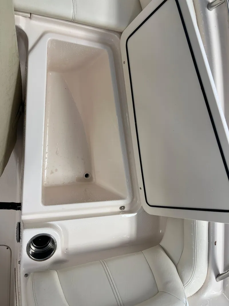 Slide: The Image of 2016 Grady-White Freedom 225 boat storage compartment with open lid. - 16