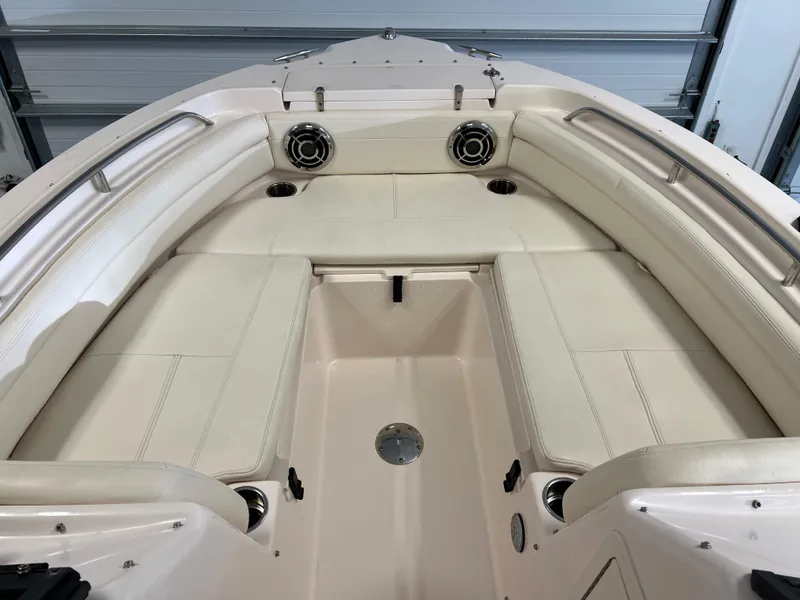 Slide: The Image of 2016 Grady-White Freedom 225 boat interior with cushioned seating and cup holders. - 17