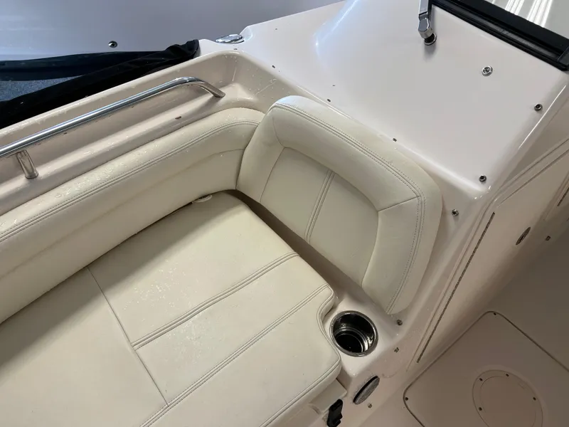 Slide: The Image of 2016 Grady-White Freedom 225 boat interior with white cushioned seating and cup holder. - 19