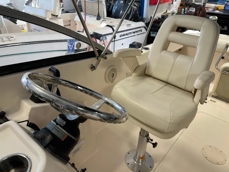 Slide: The Image of 2016 Grady-White Freedom 225 boat cockpit with steering wheel and captain's chair. - 21
