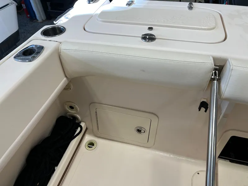 Slide: The Image of 2016 Grady-White Freedom 225 boat interior, featuring storage compartments and cup holders. - 25
