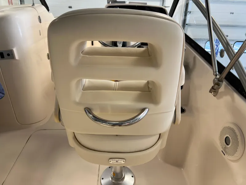 Slide: The Image of 2016 Grady-White Freedom 225 boat captain's chair and helm station. - 26