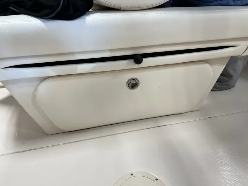 Slide: The Image of 2016 Grady-White Freedom 225 boat storage compartment with lock. - 28