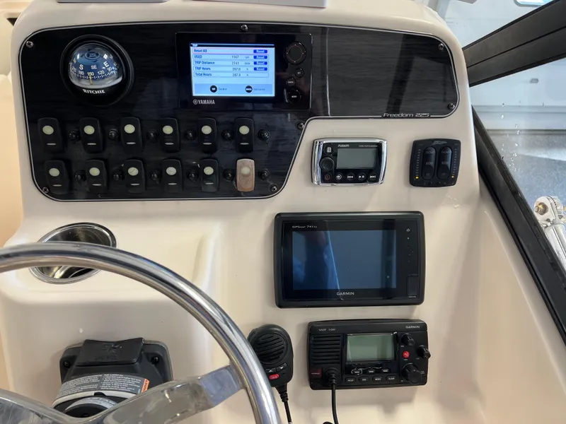 Slide: The Image of Control panel of a 2016 Grady-White Freedom 225 boat with navigation instruments. - 3