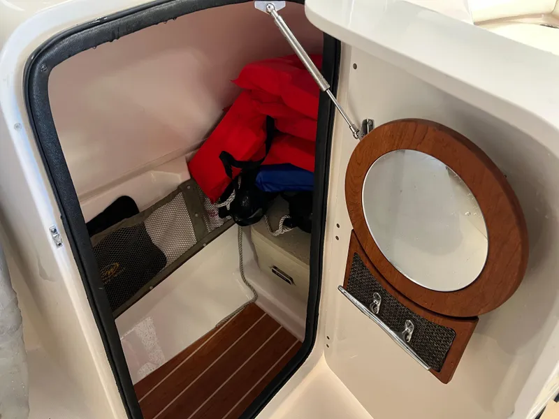 Slide: The Image of 2016 Grady-White Freedom 225 cabin interior with life jackets and storage. - 30