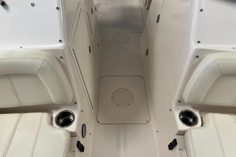 Slide: The Image of 2016 Grady-White Freedom 225 boat interior with white seating and storage compartments. - 37