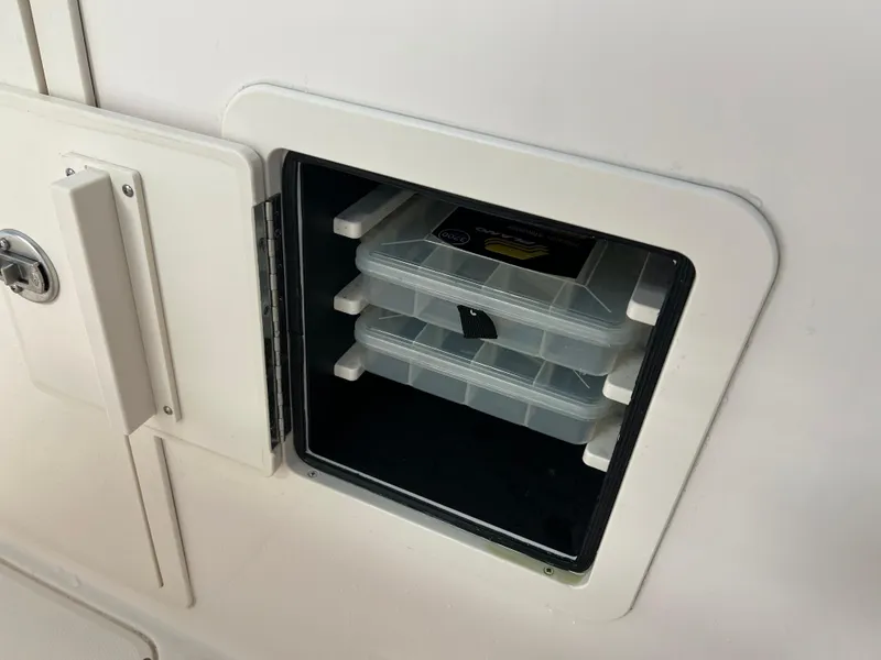 Slide: The Image of Storage compartment with tackle boxes on a 2016 Grady-White Freedom 225 boat. - 8