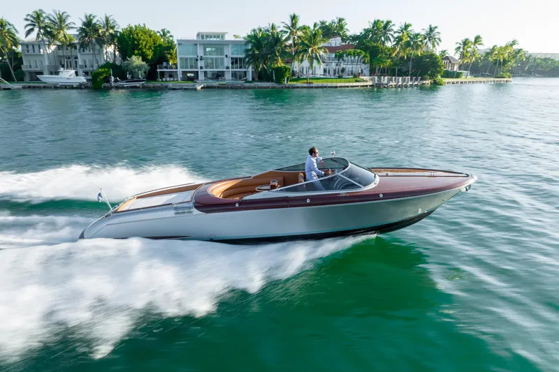 Slide: The Image of 2020 Riva Aquariva speedboat cruising on a scenic waterfront. - 13