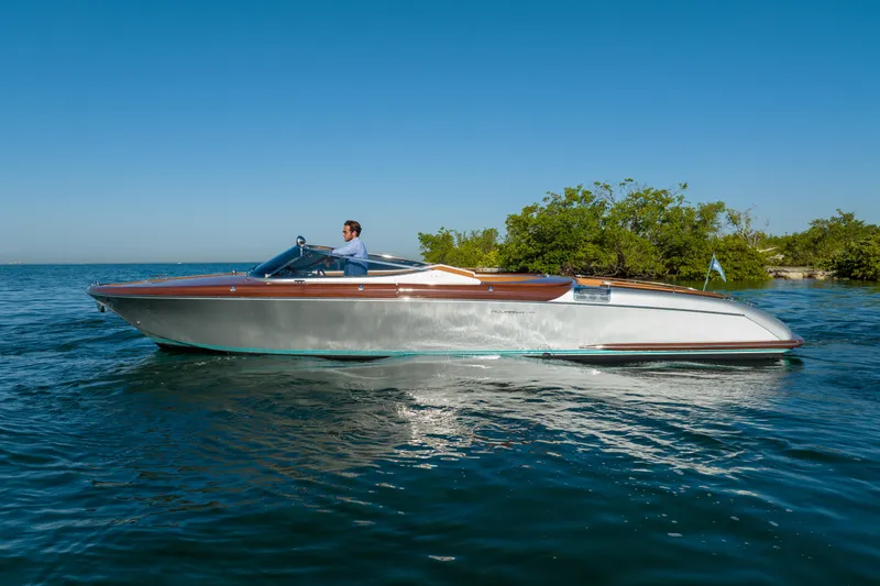 Slide: The Image of 2020 Riva Aquariva luxury speedboat cruising on clear blue water. - 16