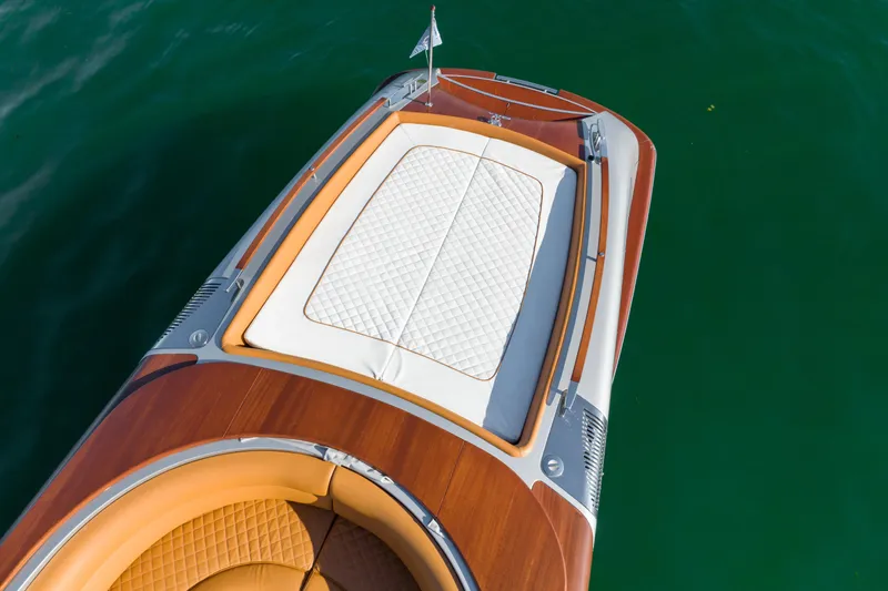 Slide: The Image of Riva Aquariva 2020 luxury boat with wooden deck and white cushioned seating. - 18