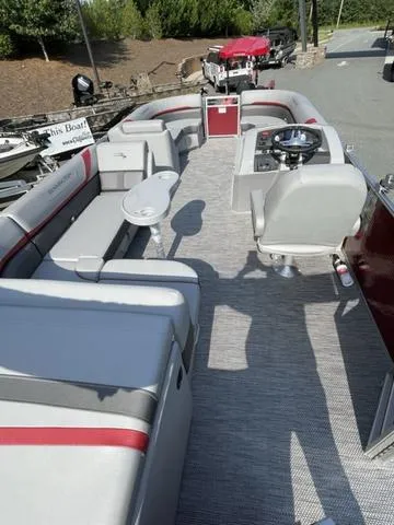Slide: The Image of 2023 Bennington 20 SXL pontoon boat interior with gray and red seating. - 4