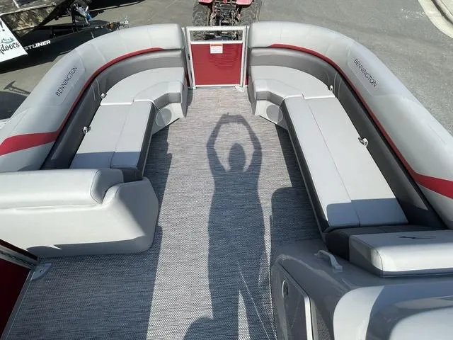 Slide: The Image of 2023 Bennington 20 SXL pontoon boat interior with gray and red seating. - 6