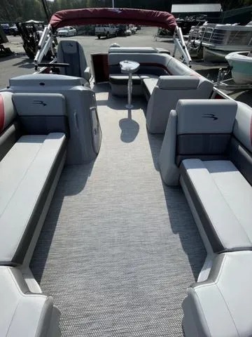 Slide: The Image of 2023 Bennington 20 SXL pontoon boat with spacious seating and modern design. - 7