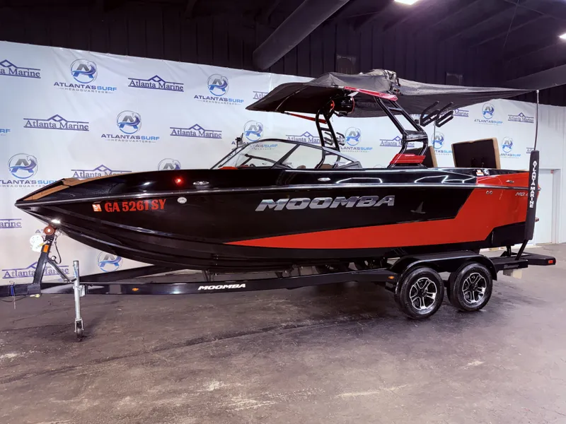 The Image of 2023 Moomba Mojo boat in black and red on trailer. - 1