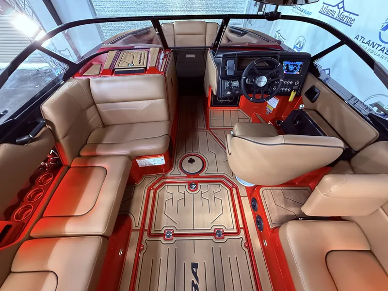 Slide: The Image of Interior of a 2023 Moomba Mojo boat with beige seating and red accents. - 21