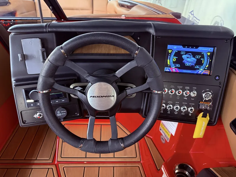 Slide: The Image of Steering wheel and dashboard of a 2023 Moomba Mojo boat. - 23