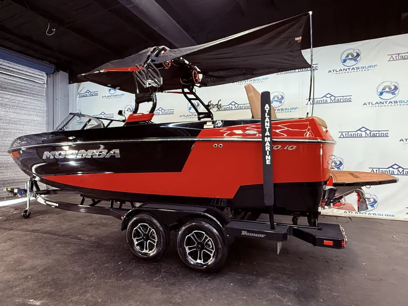 Slide: The Image of 2023 Moomba Mojo boat displayed in a showroom. - 3