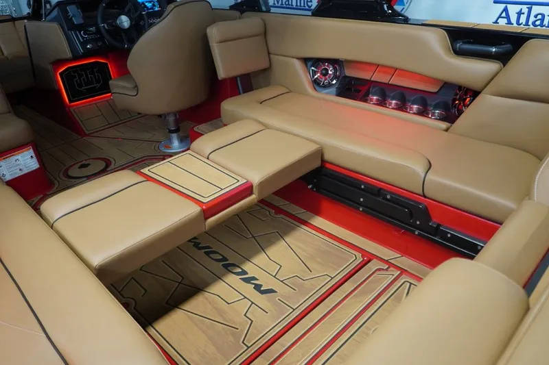 Slide: The Image of 2023 Moomba Mojo interior with beige seating and red lighting. - 33
