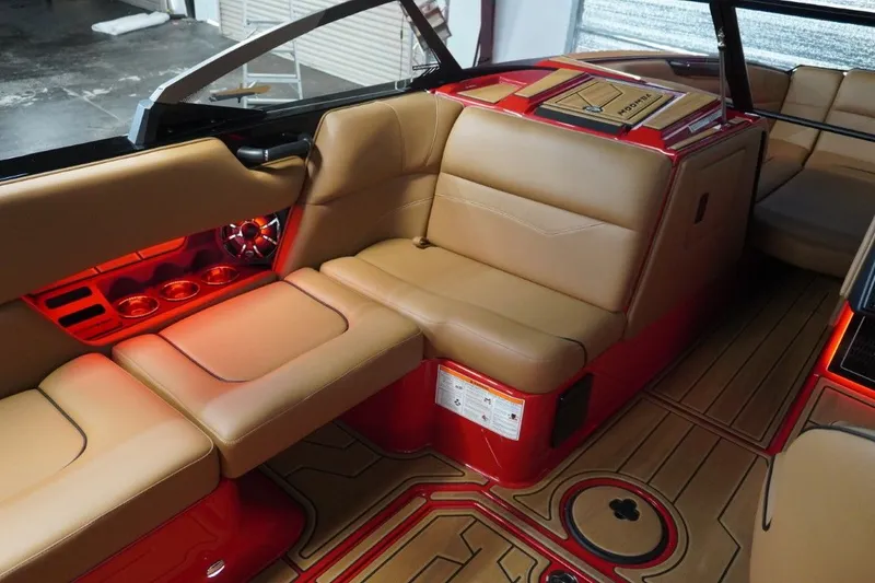 Slide: The Image of Interior of a 2023 Moomba Mojo boat with beige seats and red lighting. - 34