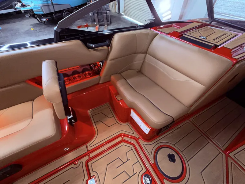Slide: The Image of Interior of a 2023 Moomba Mojo boat with beige seats and red accents. - 38