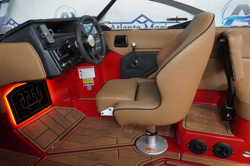 Slide: The Image of 2023 Moomba Mojo boat interior with brown seats and red flooring. - 42