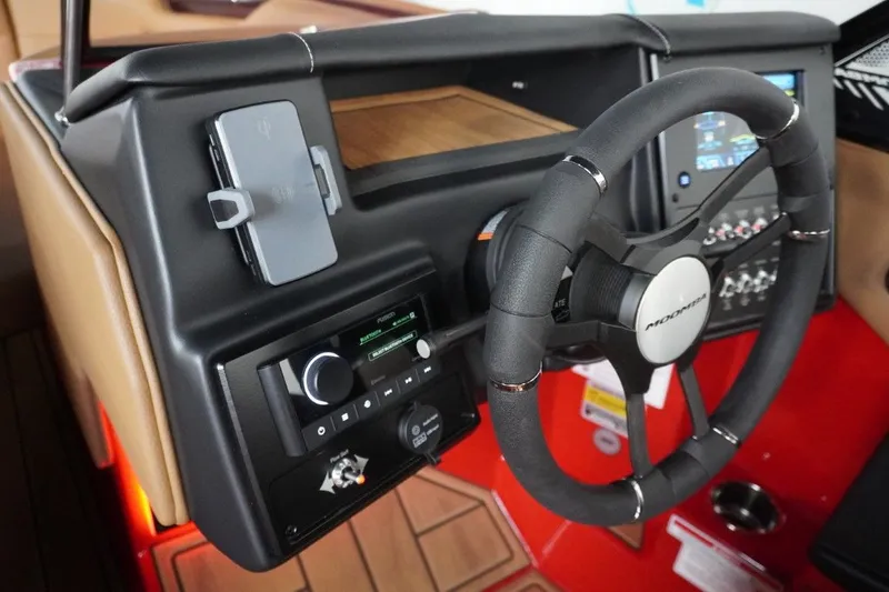 Slide: The Image of 2023 Moomba Mojo boat dashboard with steering wheel and controls. - 43