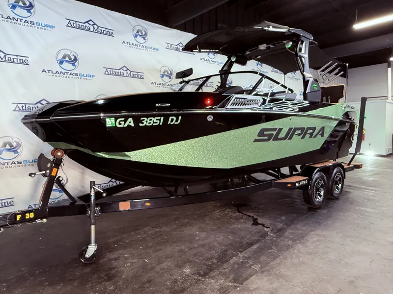 Slide: The Image of 2023 Supra SA 400 boat on trailer in showroom. - 13