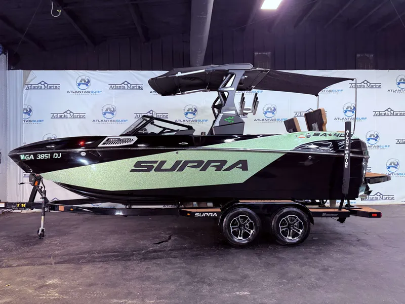Slide: The Image of 2023 Supra SA 400 boat displayed in a showroom. - 2