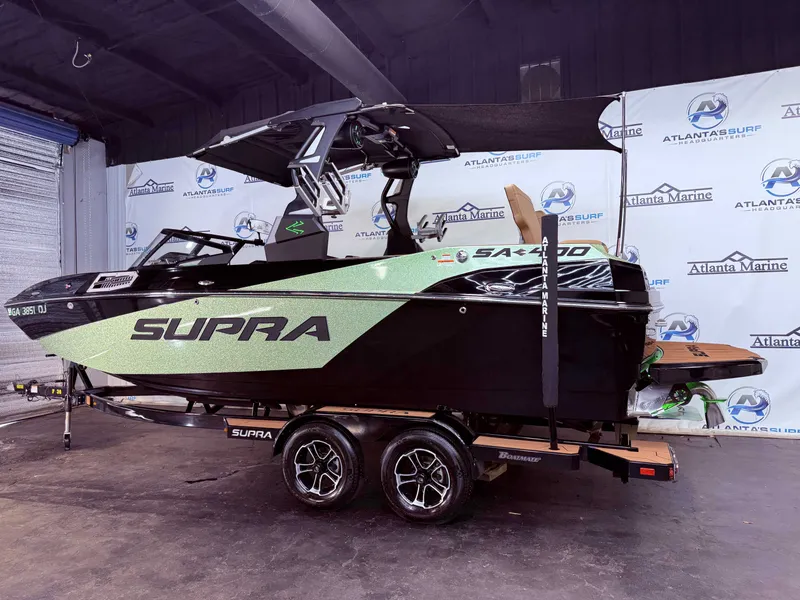Slide: The Image of 2023 Supra SA 400 boat in a showroom. - 3