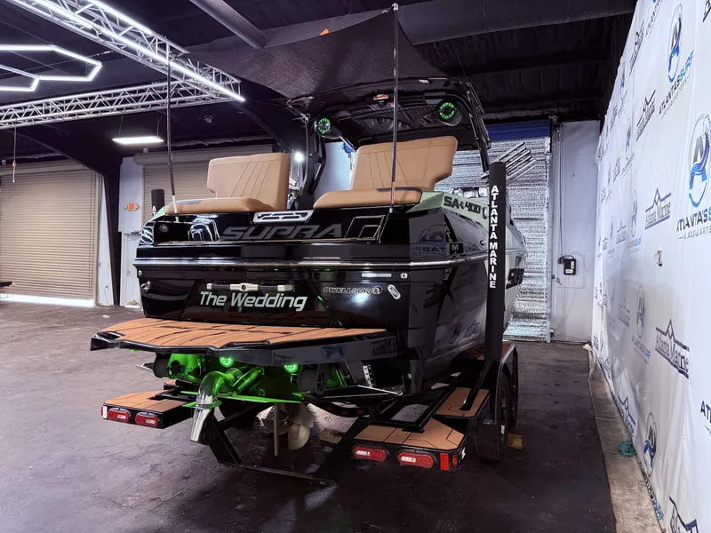 Slide: The Image of 2023 Supra SA 400 boat in a warehouse setting. - 7