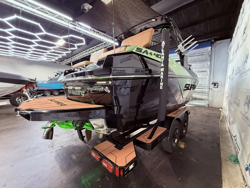 Slide: The Image of 2023 Supra SA 400 boat in showroom with modern design. - 8