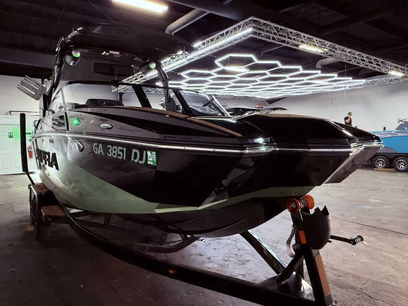 Slide: The Image of 2023 Supra SA 400 boat in a well-lit showroom. - 9