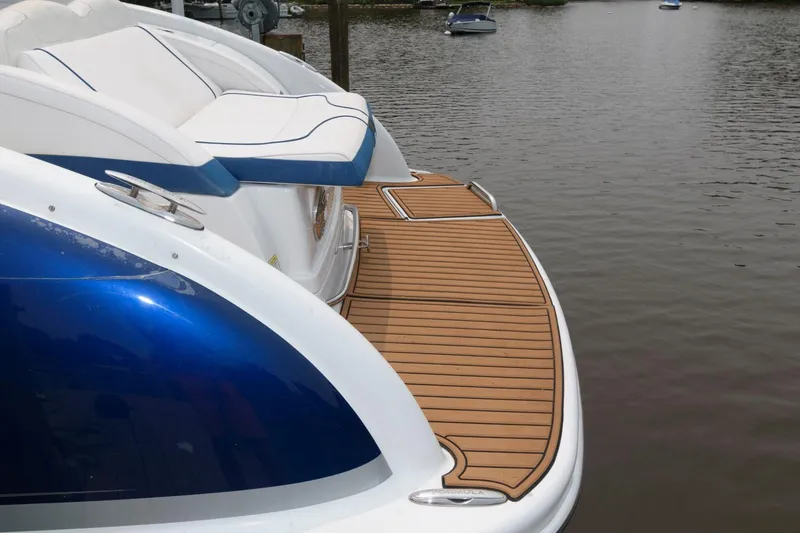 Slide: The Image of 2012 Formula 310 Bowrider boat with teak swim platform on calm water. - 15