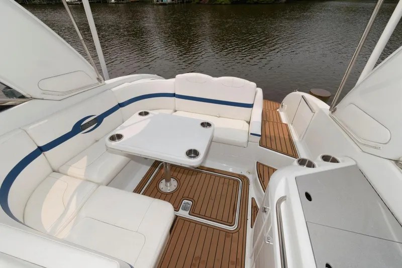 Slide: The Image of 2012 Formula 310 Bowrider boat with white seating and wooden deck. - 5