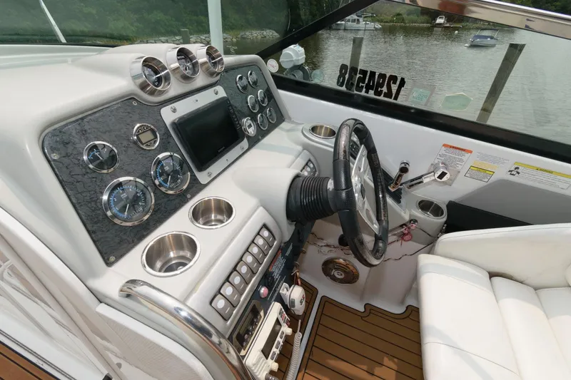 Slide: The Image of 2012 Formula 310 Bowrider boat dashboard with steering wheel and control panel. - 7
