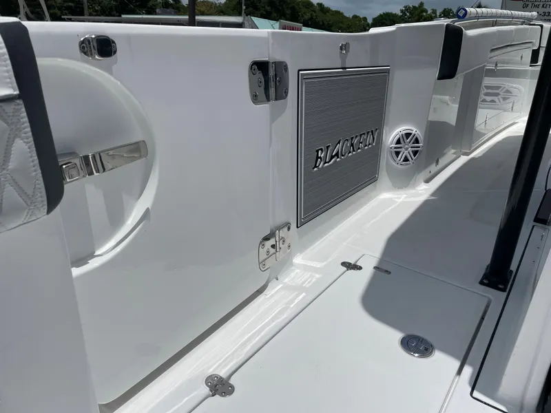 Slide: The Image of 2024 Blackfin 332cc boat interior, featuring sleek white design and stainless steel fixtures. - 15