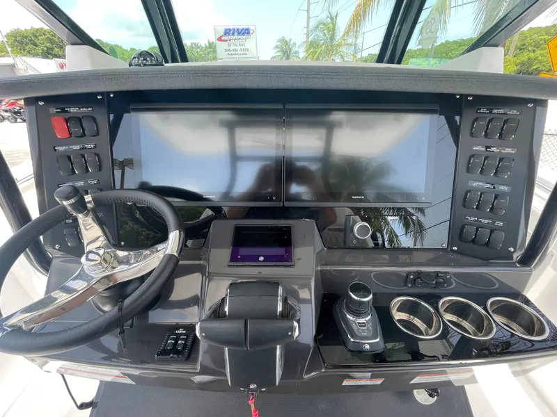 Slide: The Image of 2024 Blackfin 332cc boat dashboard with dual screens and modern controls. - 18