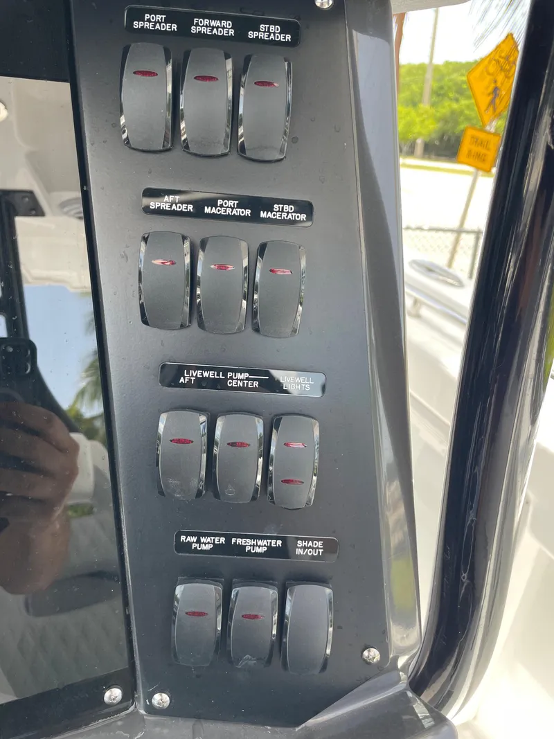 Slide: The Image of Control panel of a 2024 Blackfin 332cc boat with various switches. - 19