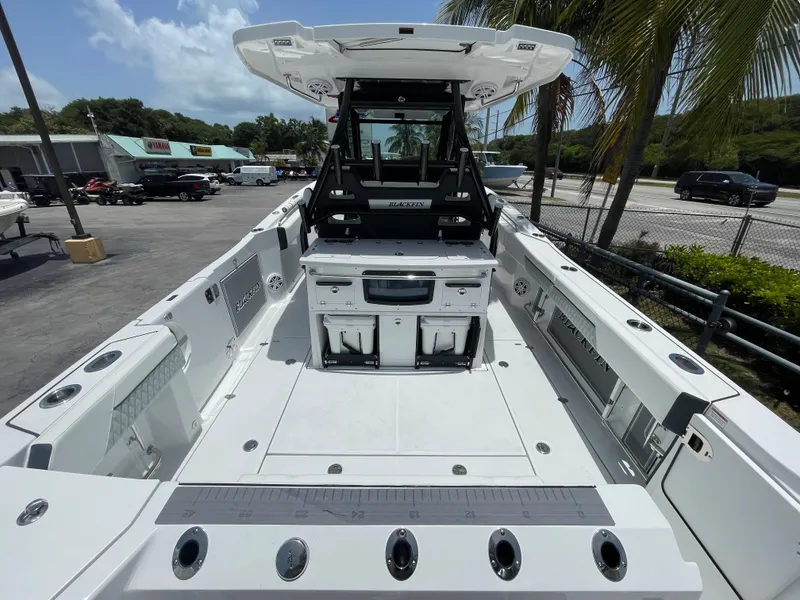 Slide: The Image of 2024 Blackfin 332cc boat interior with seating and storage compartments. - 2