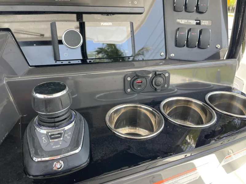 Slide: The Image of 2024 Blackfin 332cc boat control panel with joystick and cup holders. - 20