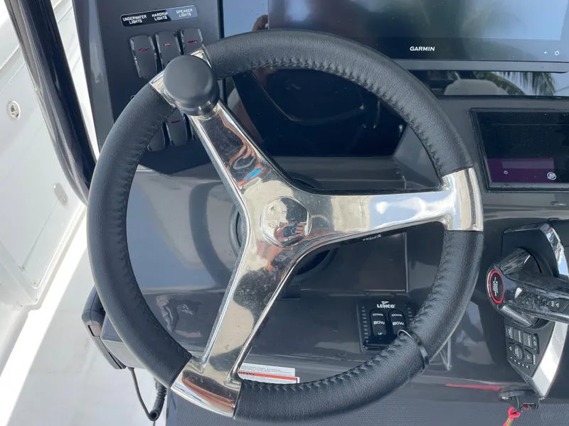 Slide: The Image of 2024 Blackfin 332cc boat steering wheel and control panel. - 23