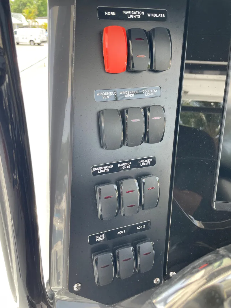 Slide: The Image of Control panel of a 2024 Blackfin 332cc boat with various switches. - 24