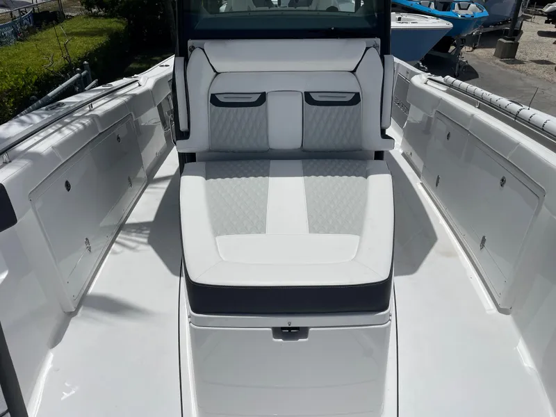 Slide: The Image of 2024 Blackfin 332cc boat interior with white cushioned seating. - 34