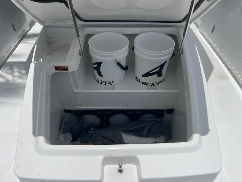 Slide: The Image of 2024 Blackfin 332cc storage compartment with two branded buckets. - 36