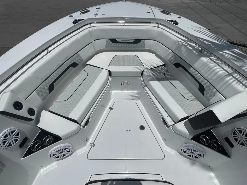 Slide: The Image of 2024 Blackfin 332cc boat interior with white cushioned seating and built-in speakers. - 39