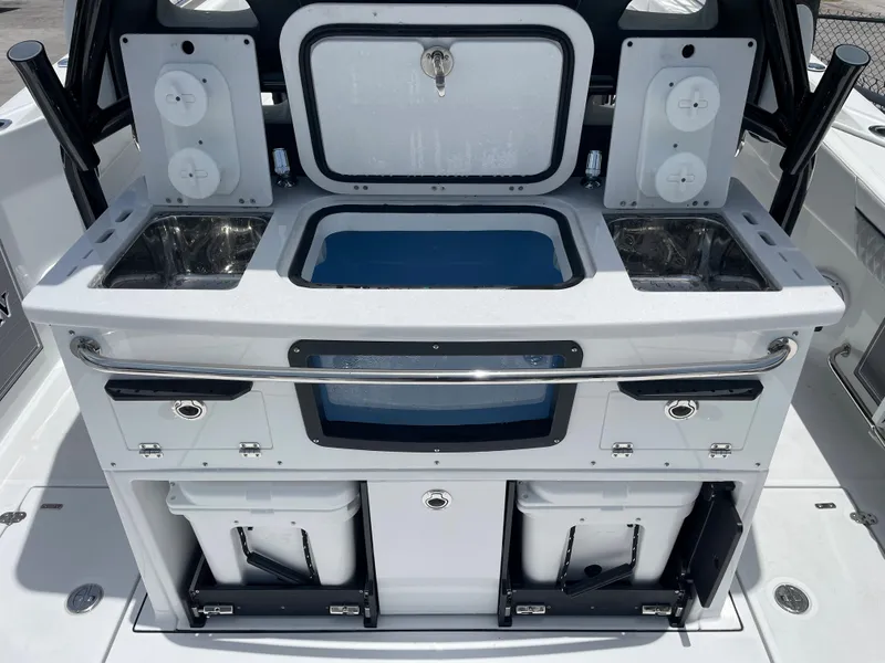 Slide: The Image of 2024 Blackfin 332cc boat with dual sinks, storage compartments, and a central livewell. - 4