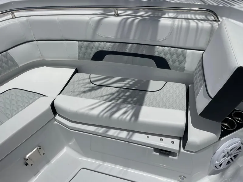 Slide: The Image of 2024 Blackfin 332cc boat interior with cushioned seating and diamond stitching. - 40