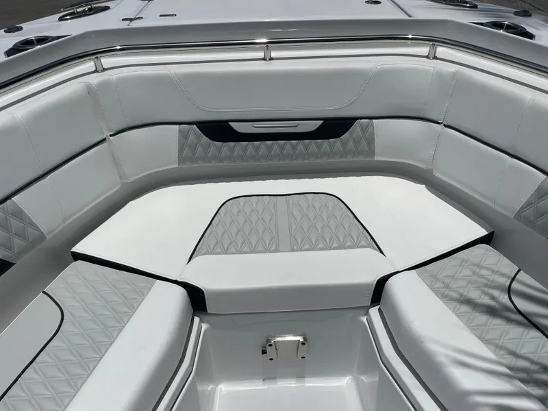 Slide: The Image of 2024 Blackfin 332cc boat interior with cushioned seating and diamond-patterned upholstery. - 41