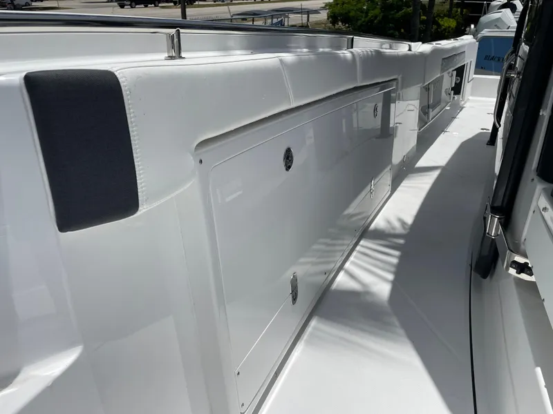 Slide: The Image of 2024 Blackfin 332cc boat deck with storage compartments and padded rail. - 43