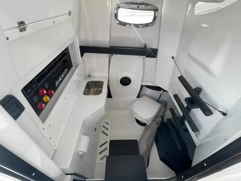 Slide: The Image of 2024 Blackfin 332cc boat interior with control panel, sink, and seating. - 45